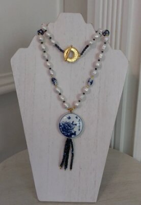 Pearl necklace with a blue and white porcelain medallion and tassel